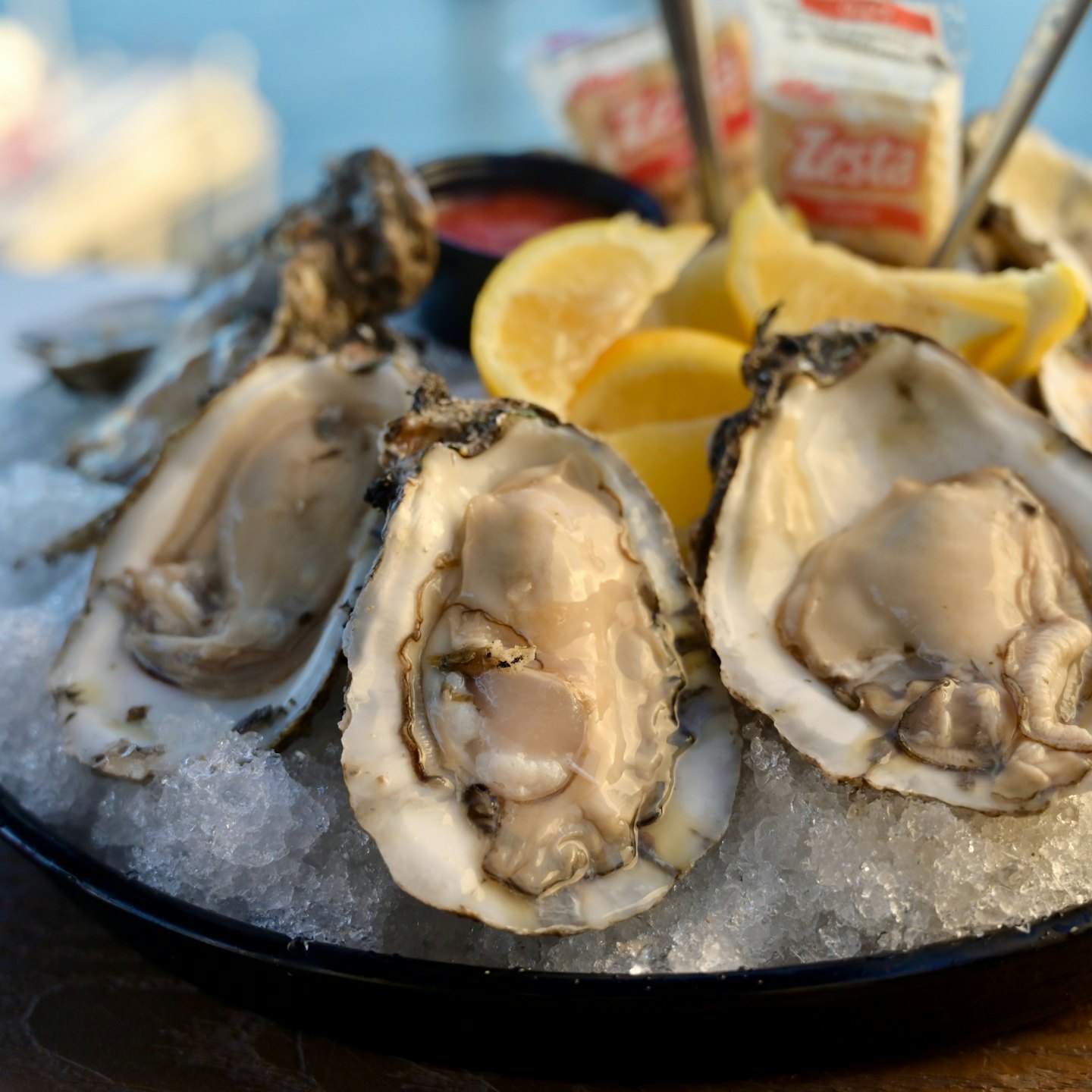 Freshly shucked oysters served with lemon wedges and cocktail sauce.